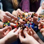 people holding miniature figures